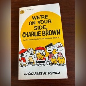 Vintage paperback We're On Your Side, Charlie Brown Book, pages tight to binding